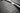 Close-up of dark rubber cargo mat texture, raised ridges and water-channel lines