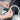 Hands attaching a flexible LED light strip to the trunk trim of a Model 3
