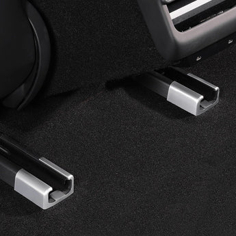 Rear seat rail corner protector with silver metal trim on dark carpet