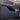 Black door kick protector panel installed on the car door lower panel with stitched edges