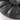 Close-up of dark gray wheel cover spokes with smooth blade accents