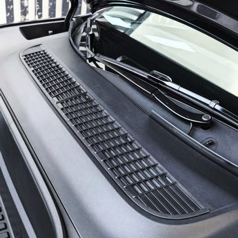 Black air intake vent cover with rectangular grid mesh and raised channels