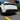 Black rear bumper diffuser add-on with angular fins and sculpted lower trim