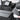 Gray camping bed extension board in car rear seat with stacked fold sections