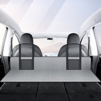 Gray camping bed extension board set up across the rear seat area