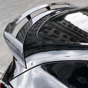 Rear trunk spoiler wing with glossy dark finish and carbon-fiber texture detail