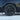 Multi-spoke wheel cover in dark finish with center cap and tire