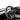 Carbon fiber sport steering wheel with black perforated rim and carbon fiber spoke trim.