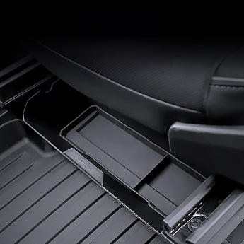 Black under-seat storage box with open compartment next to seat base console.
