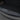 Trunk sill plate cover with diagonal line texture and raised icons, dark finish