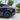 Matte black wheel cover with aero spoke design and circular center cap on rear wheel
