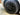 Front wheel close-up: black turbine-style wheel cover with circular center cap