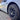 Aero wheel cover with fin-style spokes and gray center cap on an 18-inch wheel