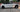Black wheel covers on both front and rear wheels of a white car