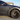 Dark multi-spoke wheel cover on car wheel with circular center cap