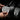 Hands holding silver brake and accelerator pedal covers with vertical grip ridges