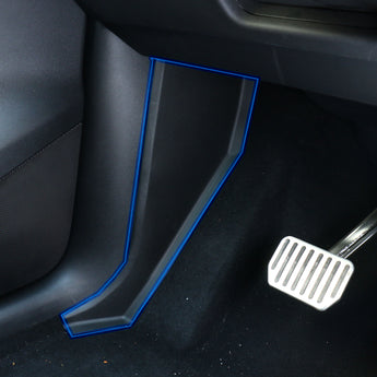 Installed black pedal side protectors with blue outline near accelerator area