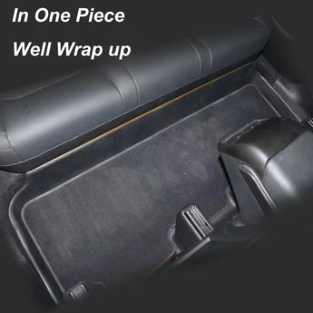 One-piece black seat base protector mat wrapping the rear bench contours