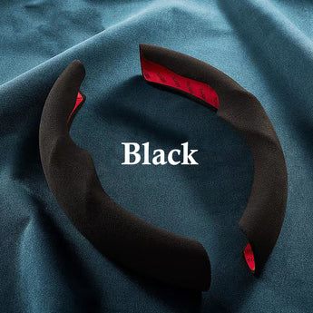 Black suede steering wheel cover with red inner accent trim and contoured non-slip grip.