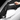 Carbon fiber side mirror cover held in hand, dark weave texture with glossy silver border