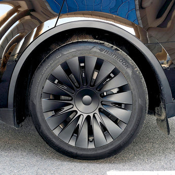 Gun gray wheel cover with turbine-style spokes and center hub on mounted tire