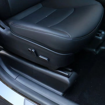 Black seat slide rail protector covering chair base track near seat controls