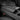 Carbon fiber armrest cover installed, textured weave surface with sharp corner edges