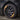 Dark gray aero wheel cover with spoke design, installed on front tire
