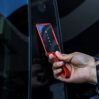 Red slim key card holder with strap, held near car door, dark card window