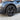 Dark gunmetal multi-spoke wheel cover on tire, 19-inch with center cap