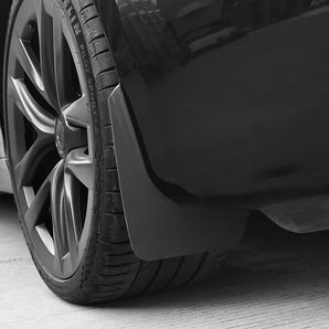 Black mud flap curved to the wheel arch, close-up on tire and rim