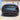 Rear bumper diffuser with integrated red LED brake light on a dark car.