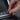Hand pressing an illuminated shortcut button on the gear selector panel