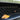 Installed front bumper grille insert with diamond-pattern wire mesh, side view.