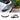V-style carbon fiber rear spoiler with dark carbon-weave lip, mounted on white car