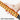 Orange soft foam handle with textured grip on extendable snow brush