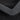 Close-up of charcoal gray alcantara charging pad frame cover texture
