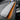 Alcantara dash trim cover with orange accent strip over textured grey surface