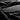 Alcantara dashboard cover fabric swatch, dark charcoal black with suede texture