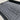 Black rubber trunk mat with textured grid tread and embossed emblem