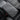 Armrest cover cushion with quilted diamond stitching on a dark gray surface