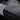 Armrest cover cushion corner detail with diamond-quilted texture on dark material