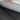 Car seat pad, gray textured flax-style fabric with white stitched border (close-up)