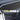 Close-up carbon-fiber door trim strip with dark weave texture