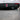 Carbon fiber rear diffuser with LED brake light, close-up of black fins and red light bar