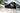 Carbon-fiber textured mirror cap on car door, dark gray triangular housing