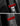 Red carbon fiber seat belt cover with black trim, close-up on anchor area