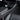 Carbon fiber center console side trim with metallic edge, dark textured weave.
