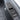 Carbon fiber hood lock cover with oval opening and horizontal slots, black weave