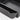 Center armrest storage box, dark gray close-up of raised lip and compartment edge